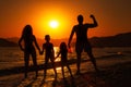 Happy family silhouettes over sunset Royalty Free Stock Photo