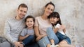 Happy family sit on floor in apartment looking at camera Royalty Free Stock Photo