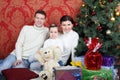 Happy family sit on floor with gifts near Christmas tree Royalty Free Stock Photo