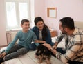 Happy family spending quality time together with their dog Royalty Free Stock Photo