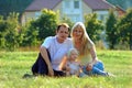 Happy family sits on meadow