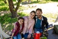 Happy Family Are Sitting On The Bench In The Gazebo In Park And Smiling. Royalty Free Stock Photo