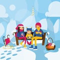 Happy family sitting on the bench on the hill in mountains and drinking hot tea or cocoa. Cold winter weather, thick snow, christm Royalty Free Stock Photo