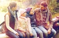 Happy family sitting on bench and talking at camp Royalty Free Stock Photo