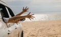 Happy family sitting in car waving hands travel outside car windows on beach travel Royalty Free Stock Photo
