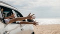 Happy family sitting in car waving hands travel outside car windows on beach Royalty Free Stock Photo