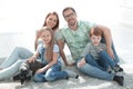 Happy family sitting on the carpet in a new apartment Royalty Free Stock Photo