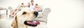 Happy family sitting on couch with their pet yellow labrador in foreground Royalty Free Stock Photo