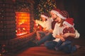 Happy family sitting by fireplace on Christmas Eve Royalty Free Stock Photo