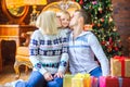 Happy family sitting on the floor near the Christmas tree Royalty Free Stock Photo