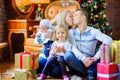 Happy family sitting on the floor near the Christmas tree Royalty Free Stock Photo