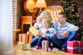 Happy family sitting on the floor near the Christmas tree Royalty Free Stock Photo