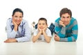 Happy family sitting on floor in a row Royalty Free Stock Photo