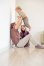 Happy family sitting on floor with their little baby. Family spending time at home with their son. Father raise his child in the Royalty Free Stock Photo