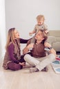 Happy family sitting on floor with their little baby. Family spending time at home with their son Royalty Free Stock Photo