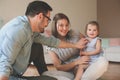Happy family sitting on floor with their little baby. Royalty Free Stock Photo