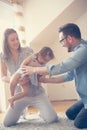 Happy family sitting on floor with their little baby. Royalty Free Stock Photo