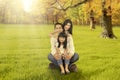 Happy family sitting on grass at autumn season Royalty Free Stock Photo