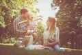 Happy family sitting on grass in the meadow. Royalty Free Stock Photo