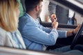 A happy family is sitting in the new car they just bought at auto shop and receiving the keys. Car, shop, buying Royalty Free Stock Photo