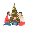 Happy Family Sitting Next to Christmas Tree, Cute Boy Holding Gift Box, People Celebrating New Year, Christmas Eve Royalty Free Stock Photo