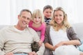 Happy family sitting with pet kitten together Royalty Free Stock Photo