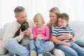 Happy family sitting with pet kitten together Royalty Free Stock Photo