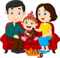 Happy family sitting on the red sofa