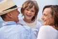 Happy family sitting on rock and watching ocean Royalty Free Stock Photo