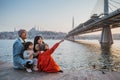 happy family sitting on the side of bosphorus Royalty Free Stock Photo