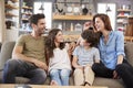 Happy Family Sitting On Sofa In Lounge Talking Together Royalty Free Stock Photo