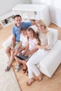 Happy family sitting on a sofa using laptop Royalty Free Stock Photo