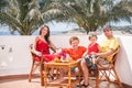 Happy family is sitting at the terrace. Royalty Free Stock Photo