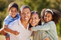 Happy, family and smile of a mom, dad and children in a park in nature having fun in summer. Portrait of parents and Royalty Free Stock Photo