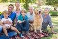 Happy family smiling at the camera with their dog Royalty Free Stock Photo