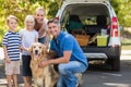 Happy family smiling at the camera with their dog Royalty Free Stock Photo