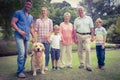 Happy family smiling at the camera with their dog Royalty Free Stock Photo