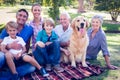 Happy family smiling at the camera with their dog Royalty Free Stock Photo