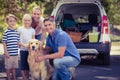 Happy family smiling at the camera with their dog Royalty Free Stock Photo