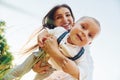 Happy family smiling and having fun. Young mother with her little son is outdoors in the agricultural field. Beautiful sunshine Royalty Free Stock Photo