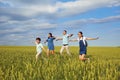 Happy family smiling running on the field in nature