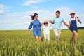 Happy family smiling running on the field in nature Royalty Free Stock Photo