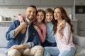 Happy Family. Smiling young parents, their little son and daughter posing together Royalty Free Stock Photo