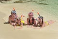 Happy family in snorkels on tropical beach