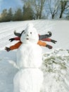 Happy family with snowman having fun in winter. Silly winter games.