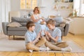 Happy family spend free time in living room, young parents are relaxing on sofa Royalty Free Stock Photo