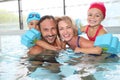 Happy family spending good time in pool