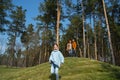 Happy family spending time in beautiful pine forest