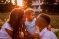 Happy family spending time outdoors walking in park. Mother and her son hugging little toddler girl. Mother`s day Royalty Free Stock Photo