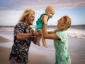 Happy family spending time on sandy beach. Joyful mother, father and baby son. Outdoor activity on summer vacations with child. Royalty Free Stock Photo